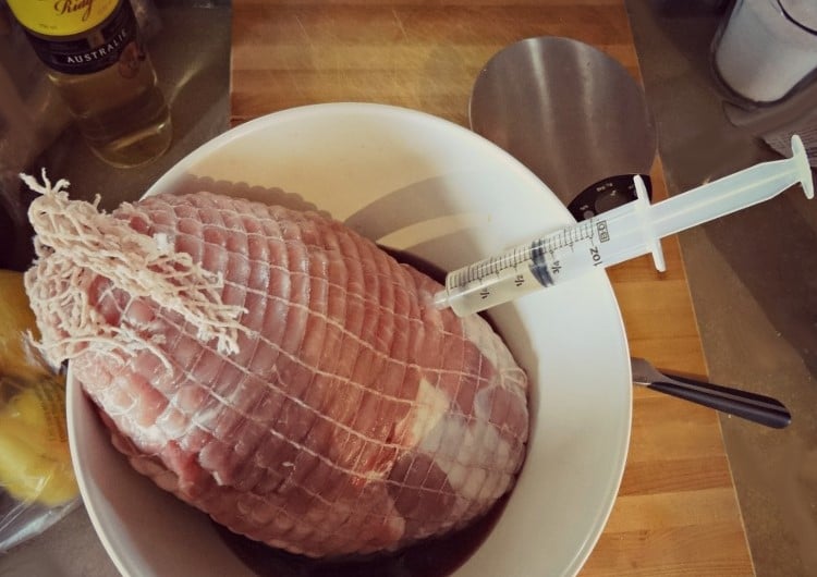 Injection of white wine into a ham